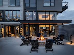 A modern house with a patio and a fire pit.