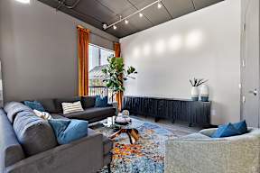 A living room with a grey couch and a coffee table.