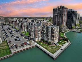 A cityscape with a river and apartment buildings.