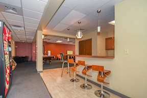 A conference room with a long table and chairs.