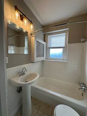 a bathroom with a sink toilet and a bath tub