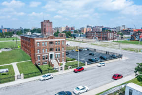 an aerial view of an empty parking lot in front of a brick building