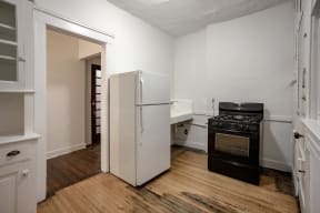 a kitchen with a refrigerator and a stove and a sink