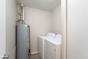 a small laundry room with a washer and dryer and a refrigerator