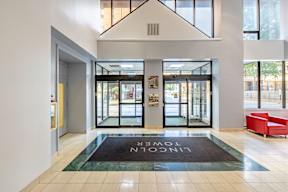 a lobby with a rug that says in the center of