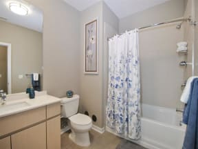 a bathroom with a white toilet next to a bath tub