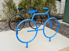 a blue bike rack with two bikes on it