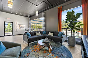 A modern living room with a large grey sofa and a coffee table.