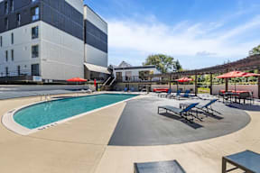 A large outdoor pool area with a slide and seating.