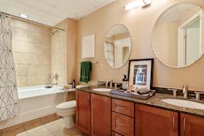 A bathroom with a toilet, sink, and shower.