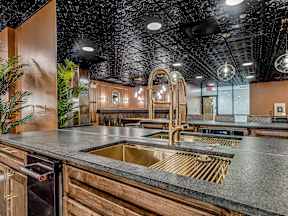 A kitchen with a sink and a counter.