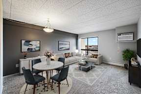 A living room with a dining table and chairs.
