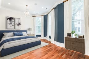 a bedroom with blue and white walls and a bed