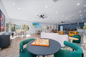 A room with a chess board on the table.