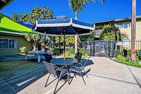 A patio with a table and chairs under a canopy.