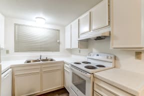 Kitchen area with a stove and sink.