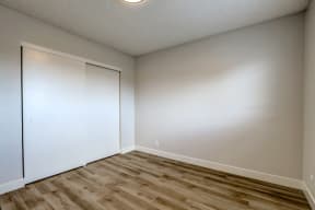 spacious room with hard wood floors