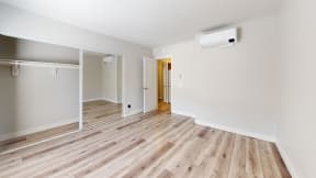 the living room and dining room of an apartment with wood flooring at Charter Oaks Apartments, California, 91360