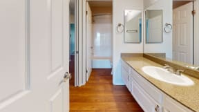 a bathroom with a sink and a mirror at Charter Oaks Apartments, California, 91360