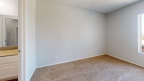 an empty room with a bathroom and a window at Charter Oaks Apartments, California, 91360