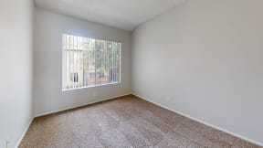 an empty room with carpet and a window at Charter Oaks Apartments, California, 91360