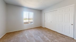 an empty room with carpet and a window at Charter Oaks Apartments, California, 91360