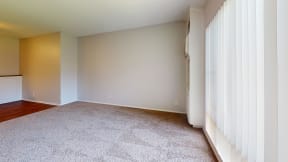 an empty living room with white curtains and carpet at Charter Oaks Apartments, California, 91360