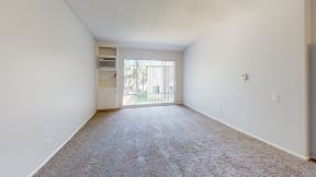 a spacious living room with carpet and a door to a balcony at Charter Oaks Apartments, California, 91360