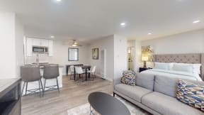 a living room with a couch and a kitchen with a bed at Charter Oaks Apartments, California, 91360