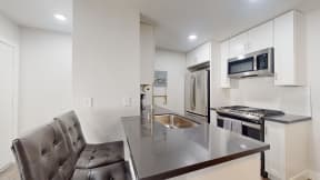 a kitchen with a counter top and a sink at Charter Oaks Apartments, California