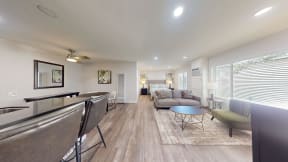 a living room with couches and a bar and a dining table at Charter Oaks Apartments, California