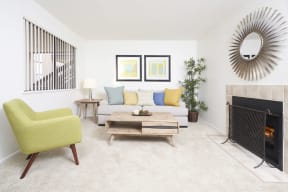 Apartment Thousand Oaks CA - The Knolls - Living Area with Green Chair, Carpeting, and Fireplace