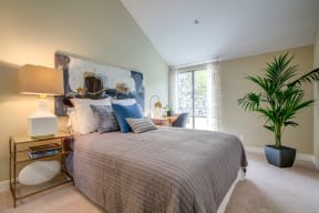 Pet-Friendly Apartments In Mountain View, CA - Americana Apartments - Spacious Bedroom With High Ceilings, Carpet Flooring, And A Window