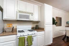 Kitchen With White Appliances, and Modern Wood Cabinets at Barrington Place, Rancho Cucamonga, 91739