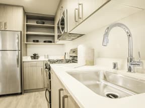 Kitchen with stainless steel appliances at MODE, San Mateo, California