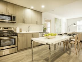 Kitchen with stainless steel appliances and dining area at MODE, San Mateo, 94403