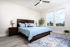model bedroom with a bed and a ceiling fan at Mihir Taylor, Taylor