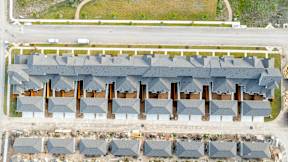 an aerial view of a row of roofs in a parking lot at Mihir Taylor, Taylor, 76574