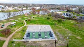 an aerial view of a basketball court on top of a green field at Mihir Taylor, Taylor, TX 76574