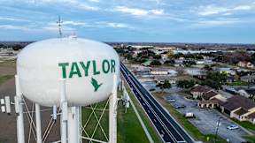 a water tower with the name of the city of taylors water tower at Mihir Taylor, Taylor, Texas