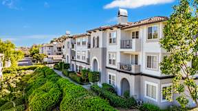 A row of houses with a clear blue sky above them at Missions at Chino Hills Apartments, Chino Hills, 91709