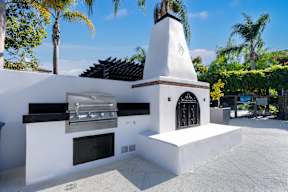 A white outdoor kitchen with a grill and oven at Missions at Chino Hills Apartments, Chino Hills, CA