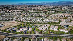 A suburban neighborhood with houses and a road at Missions at Chino Hills Apartments, Chino Hills