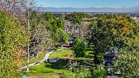 A park with a playground and a parking lot at Missions at Chino Hills Apartments, California, 91709