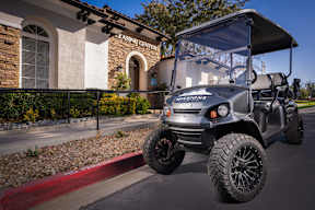 A golf cart is parked in front of a leasing center at Missions at Chino Hills Apartments, Chino Hills, California