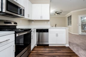 Kitchen With White Cabinets, Speckled Countertops, And Appliances.at Missions at Chino Hills, Chino Hills, CA 91709