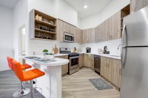 Kitchen with stainless steel appliances and bar stools at MODE, San Mateo, CA