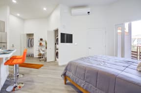Living Area Complete with Breakfast Bar, Stackable Washer and Dryer Units, and Closet Storage Space at MODE, San Mateo, CA, 94403