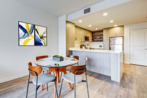 Dining area and kitchen with stainless steel appliances at MODE, San Mateo, California