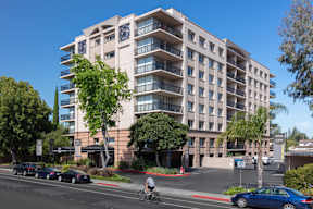 Apartments in Palo Alto, California - Tan Plaza - Exterior View of Tan Plaza Building with Trees, View of Covered Parking, Street View, and Unit Balconies